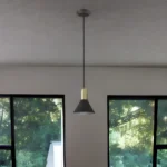Detail shot of the E26 bulb socket and gold interior of the pendant light, with crystals refracting warm light.