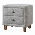 Gray boucle nightstand with two drawers and wooden legs in a modern bedroom setting