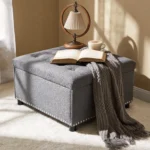 Goldoma hidden storage ottoman with fabric upholstery and nailhead trim, used as coffee table in living room