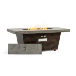 Modern metal propane fire pit on patio with glowing flames