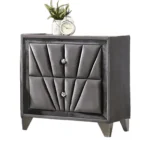 Gray fabric upholstered nightstand with chrome legs and drawers in a modern bedroom setting