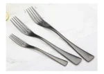 Luxury black 18/10 stainless steel cutlery set arranged on a table