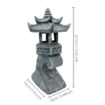 Solar pagoda lantern surrounded by lush greenery, casting soft light on garden bed.
