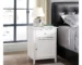 White nightstand with drawer and cabinet in a modern bedroom setting