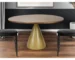 48-inch round pedestal dining table with brown wood top and gold pedestal base in a modern dining room setting