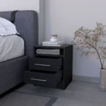 Modern black melamine nightstand with two drawers and shelf beside a bed in a bedroom