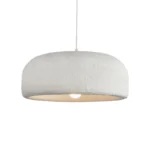 Nordic minimalist wabi-sabi wind LED pendant light with warm glow over a wooden dining table in a cozy restaurant