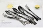 Luxury black 18/10 stainless steel cutlery set arranged on a table