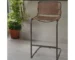 Modern leather bar stool in brown and black with metal rotating base in a home bar setting