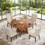 Modern round dining table with marble top and wood legs seating six in a living room