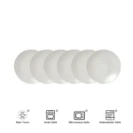 Elegant dinnerware set with white minimalist plates arranged on a wooden table