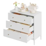 Modern white 3 drawer dresser with gold-tone knobs and lacquer finish in a bedroom setting