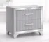 Modern acrylic nightstand drawers with two drawers and silver metal legs in a bedroom setting