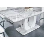 71 inch white marble dining table with pedestal base and chrome accents in a contemporary dining room setting