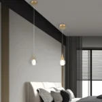 Brass globe pendant light illuminating a modern kitchen island
