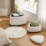 White faux fur storage ottoman set of 2 with metal legs placed in bedroom as footrest and shoe changing stool
