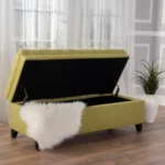 Purple fabric storage ottoman with hidden compartment and birch wood legs in a living room