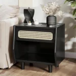 Black nightstand with rattan drawer detail and open shelf in a modern bedroom
