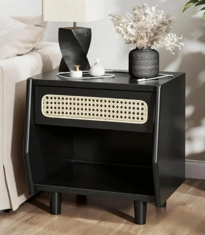 Black nightstand with rattan drawer detail and open shelf in a modern bedroom