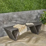 Dark gray solid wood outdoor garden bench with cast iron legs in a garden setting