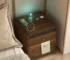 Bamboo nightstand with charging station and LED lights in a modern bedroom