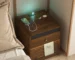 Bamboo nightstand with charging station and LED lights in a modern bedroom
