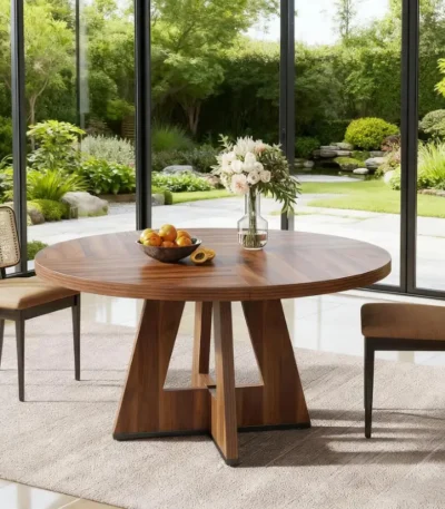 Modern round dining table with marble top and wood legs seating six in a living room