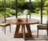 Round marble dining table with wood legs in a modern dining room setting