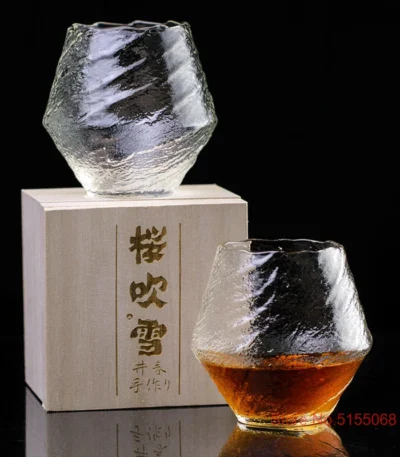 Set of hazy wine glasses with hammer pattern and snowflake design on a wooden table