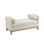 Goldoma upholstered bench daybed ottoman with wood legs and two bolster pillows in a modern living room setting