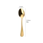 Elegant gold flatware set with fork, knife, and spoon on a white tablecloth