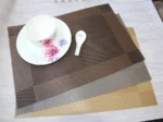Gold weave placemats on a dining table with plates and cutlery