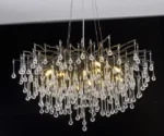Modern gold chandelier with crystal branches illuminating a dining room