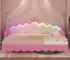 Modern twin daybed with lights featuring LED crown headboard and pull-out trundle in a bright kids' room