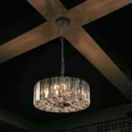 Goldoma 17-inch chrome crystal pendant chandelier with 4 lights, hanging over a modern living room dining table.