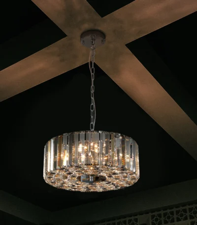 Goldoma 17-inch chrome crystal pendant chandelier with 4 lights, hanging over a modern living room dining table.
