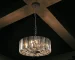 Goldoma 17-inch chrome crystal pendant chandelier with 4 lights, hanging over a modern living room dining table.
