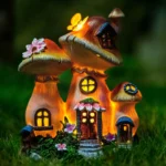 Goldoma mushroom house solar light statue glowing in a garden at dusk, resin material with warm light.