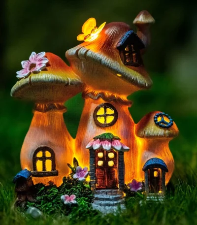 Solar garden statue mushroom house glowing at night