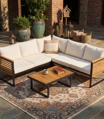 Modern outdoor corner sofa set with acacia wood frame and waterproof cushions on a patio