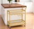 Gold metal wood bar cart with wine storage and serving trolley in a living room