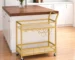Gold metal wood bar cart with wine storage and serving trolley in a living room