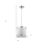 Overhead view of the hanging light with white fabric shade and silver trim, casting a warm glow on a modern kitchen