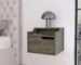 White wall mounted nightstand with drawer and dual shelves in a bedroom