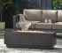 Outdoor propane fire pit in dark grey rectangular iron with glowing flames