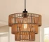 1-Light Farmhouse Rattan Boho Pendant Light with woven rope lampshade hanging over a rustic wooden kitchen island.