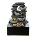 Goldoma fountain illuminated with LED lights in a dim office corner, creating a calming atmosphere, realistic stone