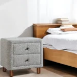 Cleo Gray Boucle Nightstand with two drawers and wooden legs in a modern living room setting
