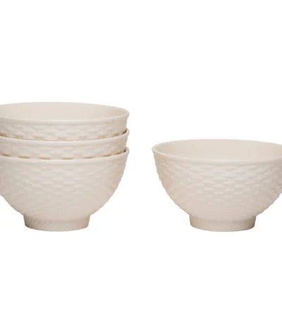 White stoneware dinnerware set with weave texture arranged on a wooden table