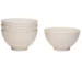 White stoneware dinnerware set with weave texture arranged on a wooden table